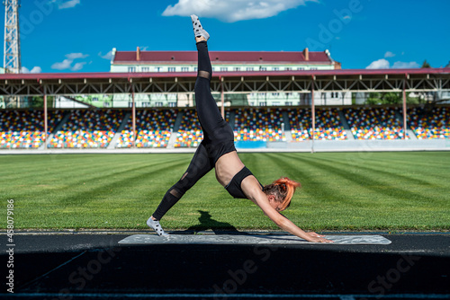 female athlete make sport workout yoga or pilates  exercise in sity staium photo