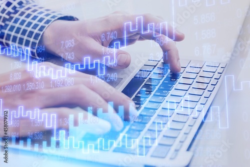 Fototapeta Naklejka Na Ścianę i Meble -  Financial charts showing growing and businessman working on the laptop