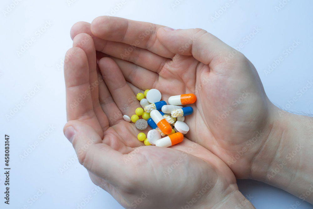 a lot of pills and tablets in the hand, consuming a lot of pills concept a lot of pills and tablets in the hand, consuming a lot of pills concept