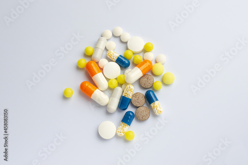 Tablets and pills on the white table, consuming a lot of pills concept