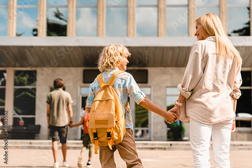 Obraz na płótnie Parents going back to school with their children after summer holidays lockdown