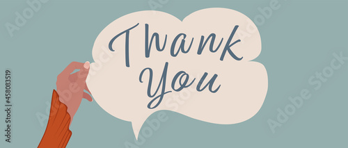 Raised arm of woman holding a label in the form of a speech bubble with the inscription -Thank You- Concept of gratitude and appreciation. Banner with copy space