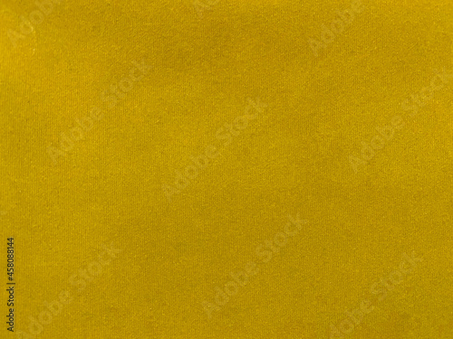 Yellow velvet fabric texture used as background. Empty yellow fabric background of soft and smooth textile material. There is space for text..