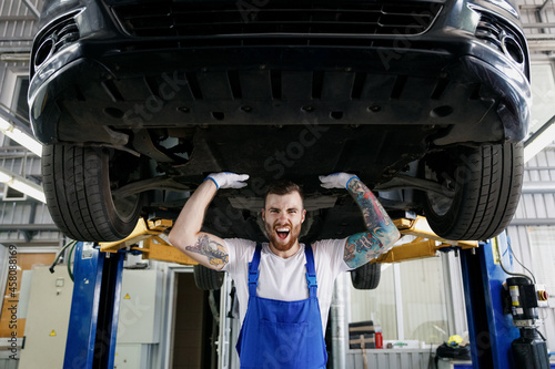 Carta da parati Strong excited young male professional technician mechanic man wears denim blue