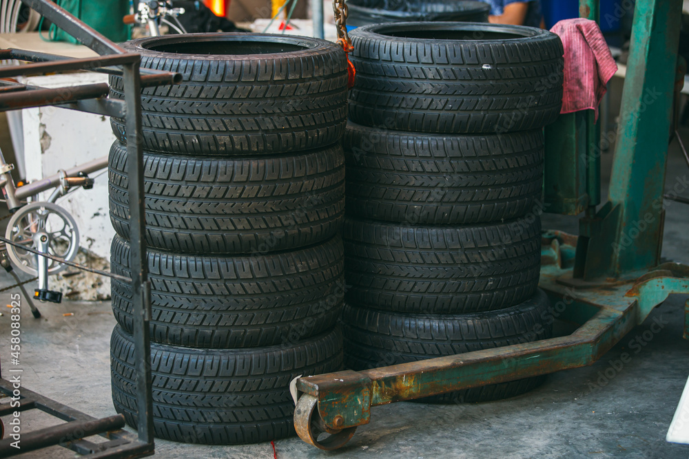 Group of new tires for race car. New tires for sale at a tire store. Car tires in the warehouse. Group of new tires for race car. New tires for sale at a tire store. Car tires in the warehouse.