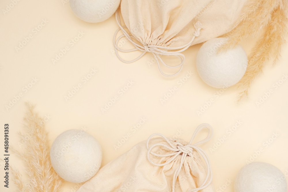 Flat Lay With Wool Dryer Balls, Cotton Bag, Pampas Grass On Beige Background. Eco Friendly Laundry Supplies. Alternative Drying Of Linen. Text Space. Flat Lay With Wool Dryer Balls, Cotton Bag, Pampas Grass On Beige Background. Eco Friendly Laundry Supplies. Alternative Drying Of Linen. Text Space.