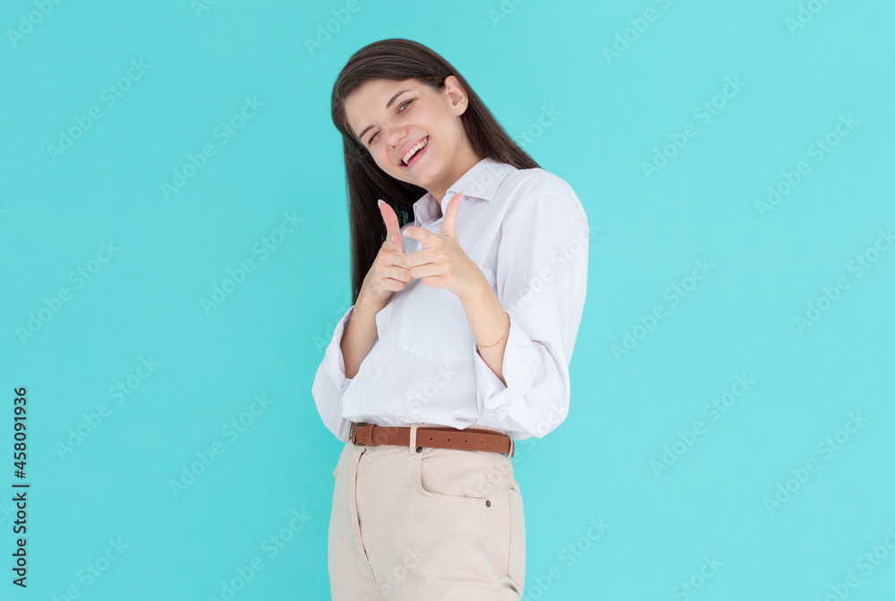 Hey you. Photo of attractive crazy funky lady directing fingers on camera blinking eye flirty person isolated blue color background Hey you. Photo of attractive crazy funky lady directing fingers on camera blinking eye flirty person isolated blue color background