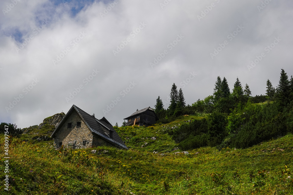 two alpine hut made of stones while hiking in austria