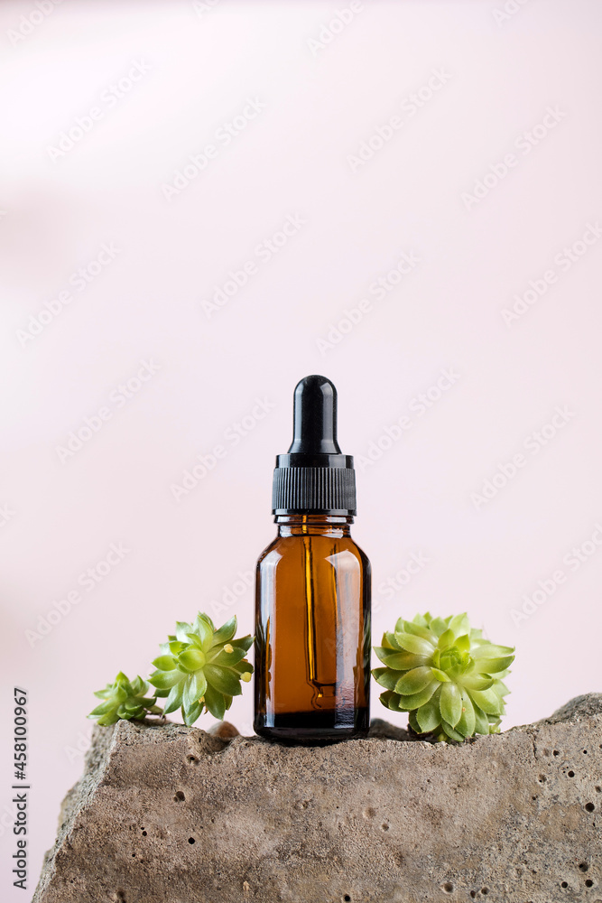 Serum for the skin of the face and body in a dark pipette surrounded by natural materials. Natural cosmetics Serum for the skin of the face and body in a dark pipette surrounded by natural materials. Natural cosmetics