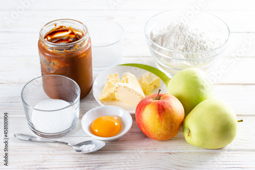 Ingredients for making apple pie on white table