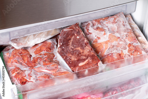 Frozen meat and meat frozen products in plastic package in the freezer. Frozen food.