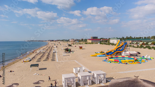 Zatoka, Odessa, Ukraine - September 4, 2021: Colorful scene of the Black Sea beach during the closing of the holiday season. Drone view of the Black Sea beach in Zatoka. Beach scene from above. photo