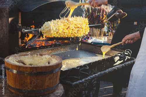 Baumkuchen, sakotis- Lithuanian cake tree. Sakotis baking process in street fair Kaziukas in Vilnius.