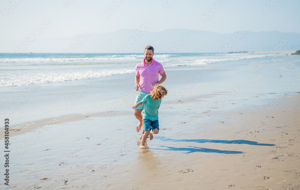 father and son family running on summer beach, family sport