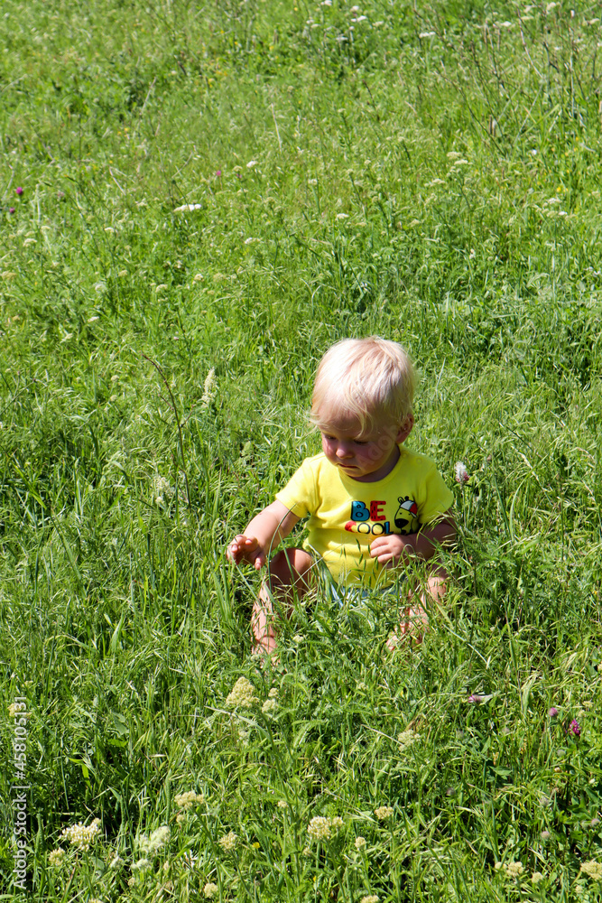little baby child explore the world in the grass in the mountains little baby child explore the world in the grass in the mountains