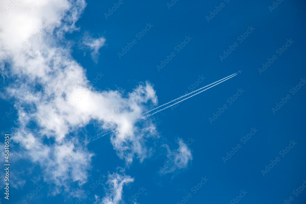 Airplane flying in the blue sky among clouds. Airplane flying in the blue sky among clouds.