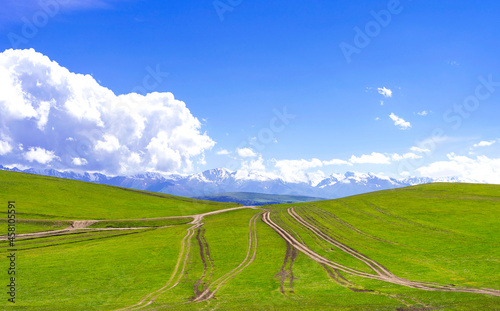 Summer landscape with green hills and dirt roads. Plateau Assy  Kazakhstan