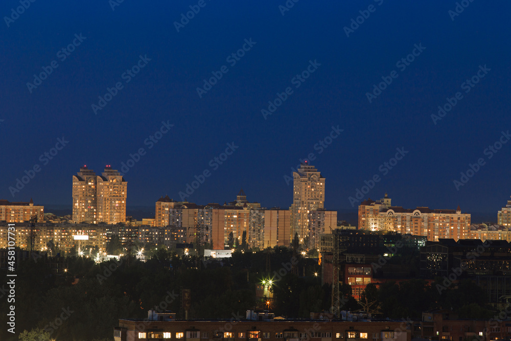 View of a nighttime metropolis with buildings of different heights