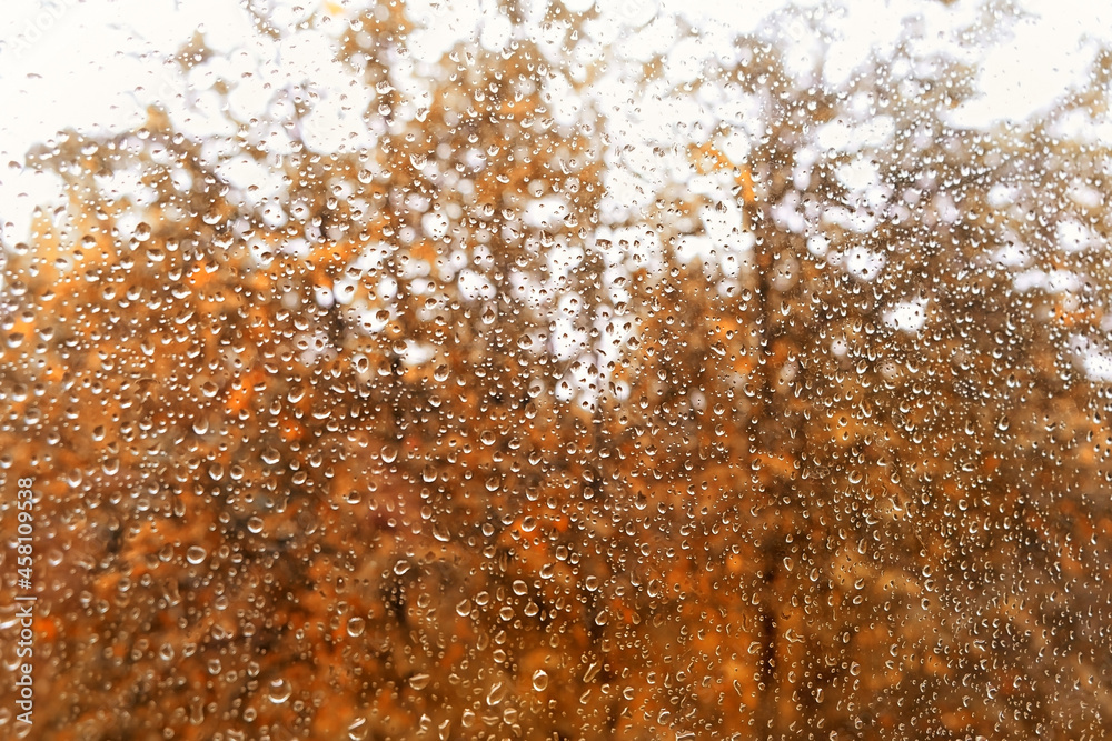 blurred abstract texture of raindrops on wet glass background. autumn rainy season. rain outside window. blurred abstract texture of raindrops on wet glass background. autumn rainy season. rain outside window.