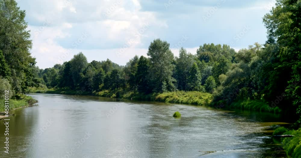 Bug river landscape view timelapse with fast river flow. Sobibor Landscape Park, Poland, Europe. Bug river landscape view timelapse with fast river flow. Sobibor Landscape Park, Poland, Europe.