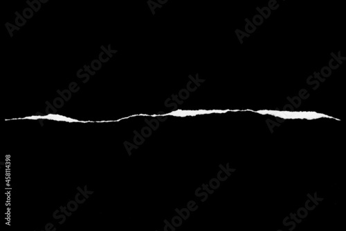 Paper tear, ripped paper edge, torn edge, isolated paper tear white on black, paper corner with space for copy photo