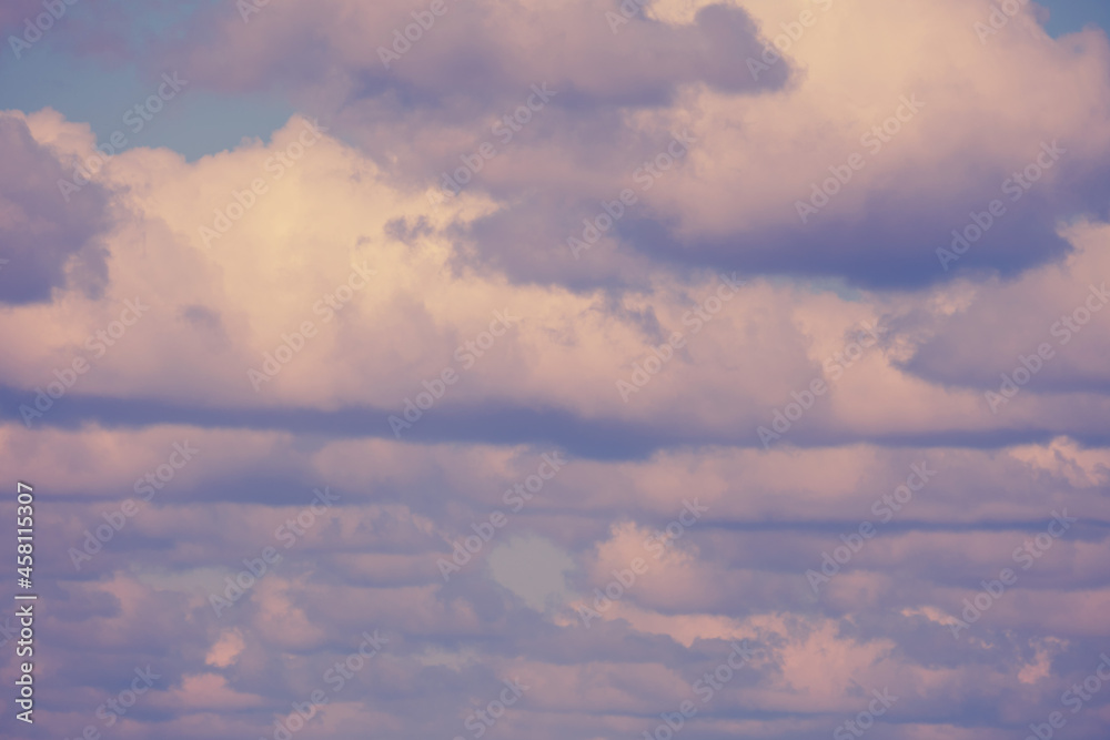 Background of many fluffy clouds on the soft evening sky