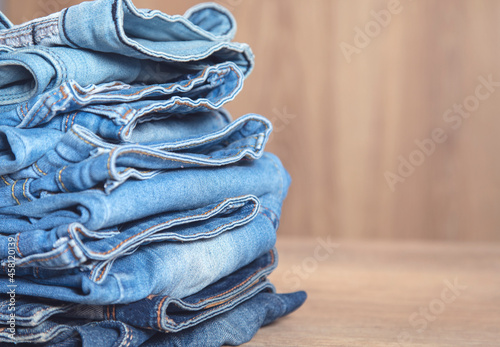 Collection of blue jeans on table