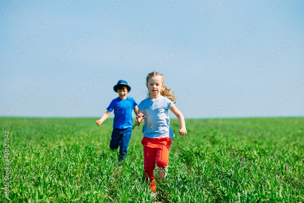 Running kids in green field during summer. Running kids in green field during summer.