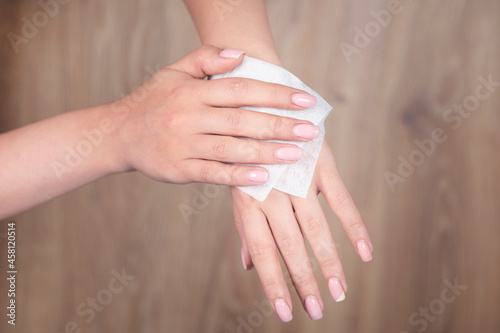 woman cleaning hand in napkin