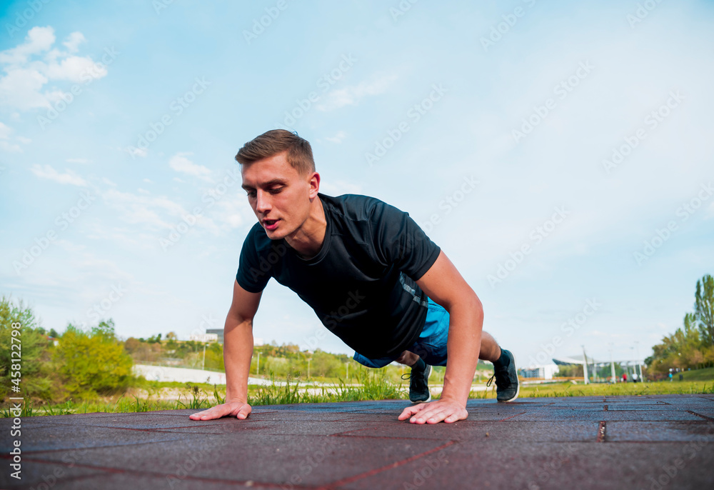 Young man push up exercise in the park for his sport outdoor