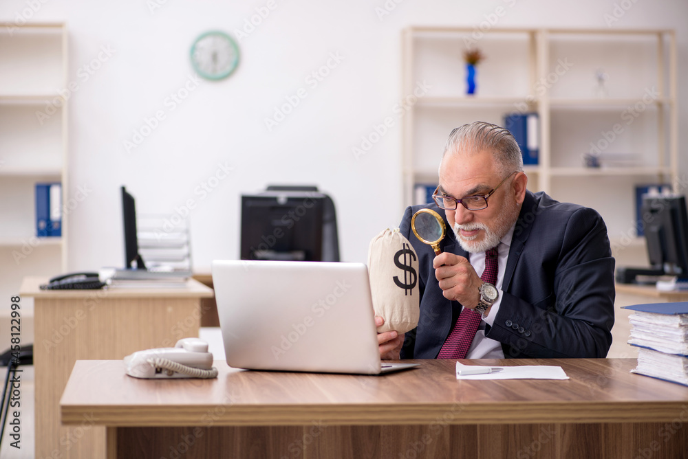 Old male employee in remuneration concept Old male employee in remuneration concept