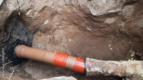 the sewer pipe burst. a dug hole for the repair of sewer pipes. care and maintenance in a private house.