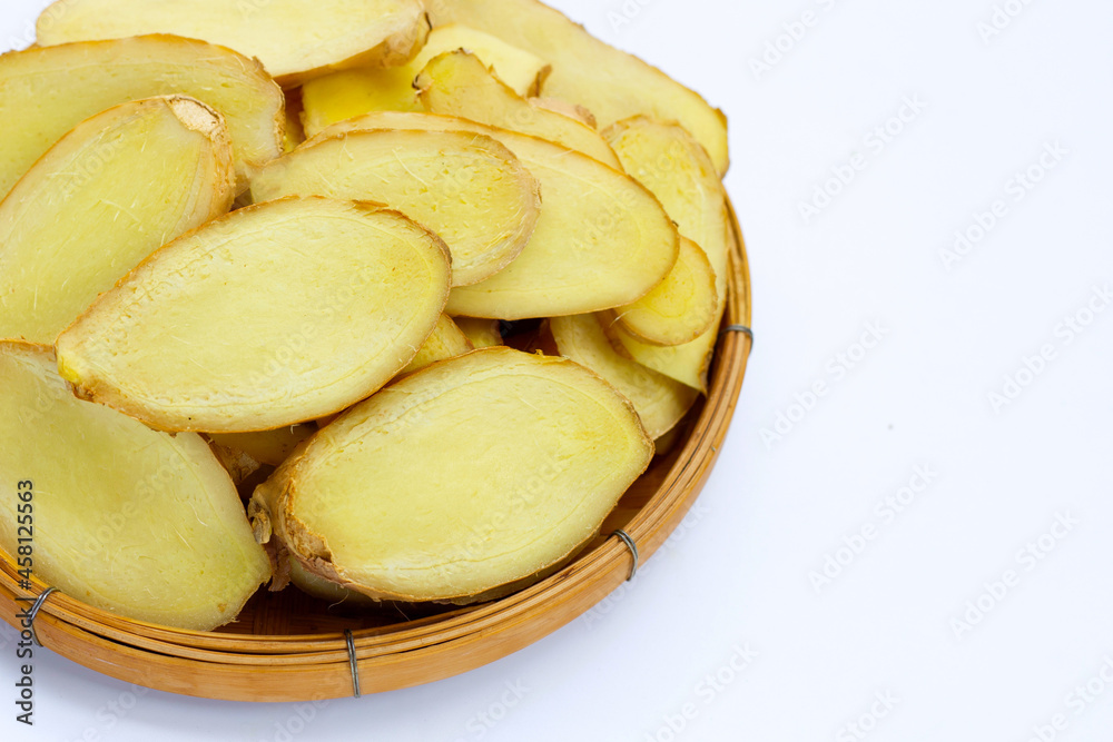 Ginger slices in bamboo basket on white background. Ginger slices in bamboo basket on white background.