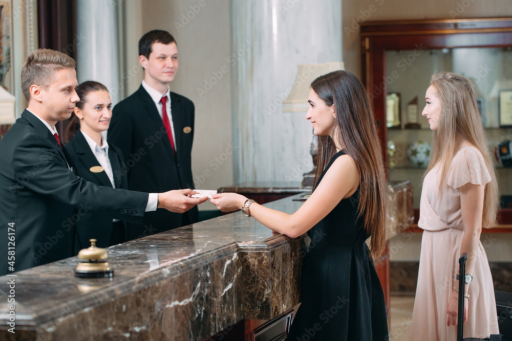 © davit85 - Picture of guests getting key card in hotel. © davit85 - Picture of guests getting key card in hotel.
