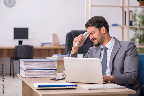 Young male employee working in the office