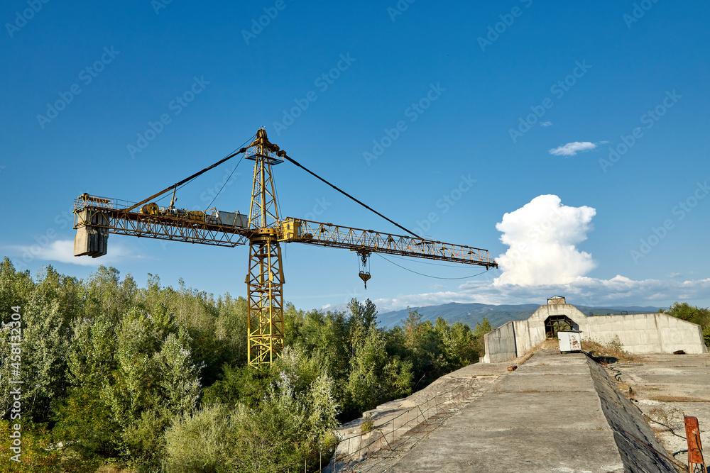 Tower crane in an abandoned hydrotechnical construction site. Tower crane in an abandoned hydrotechnical construction site.