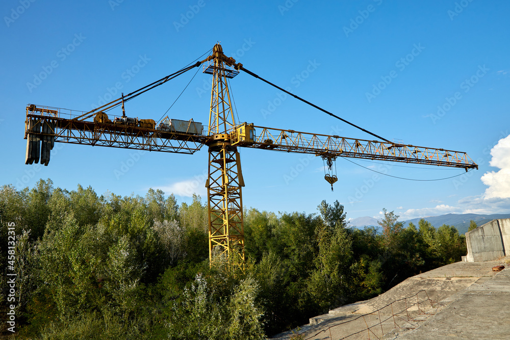 Tower crane in an abandoned hydrotechnical construction site. Tower crane in an abandoned hydrotechnical construction site.