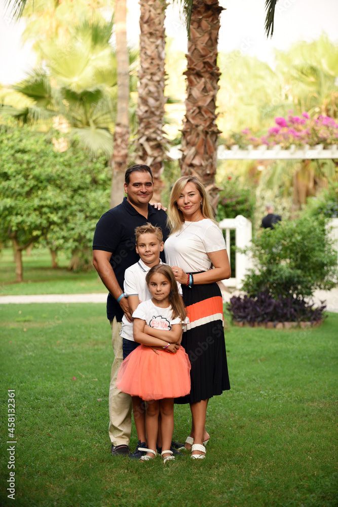 Fototapeta premium A happy family with kids in the park