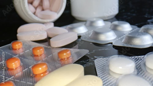 Medical drugs and capsules. Dolly shot Close up of colored medicines pills. A pile of medical drugs and capsules of different kinds.