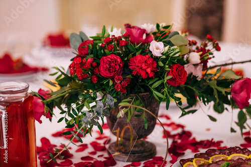Amazing wedding table decoration with red flowers on the tables