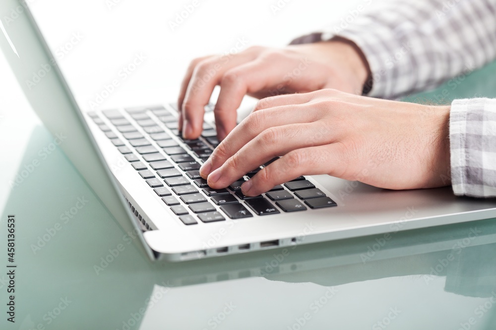 Person's hands typing on laptop computer Person's hands typing on laptop computer
