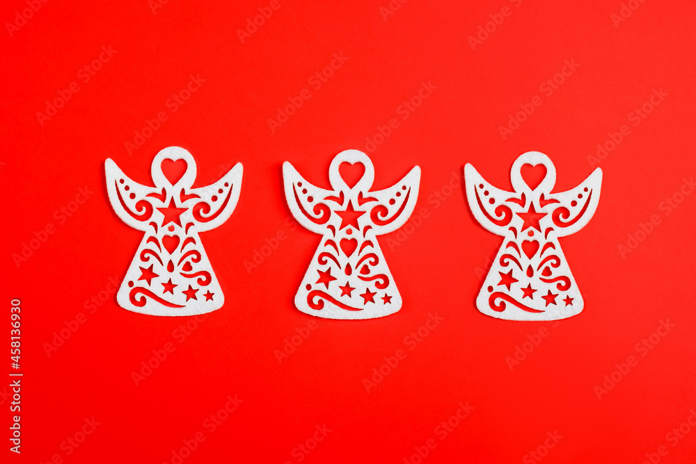 White christmas angel ornament on red background, new year toys. Xmas. White christmas angel ornament on red background, new year toys. Xmas.