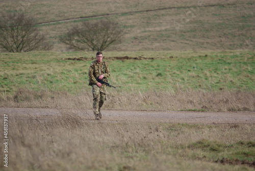 British army soldier completing an 8 mile tabbing exercise with fully loaded 25Kg bergen
