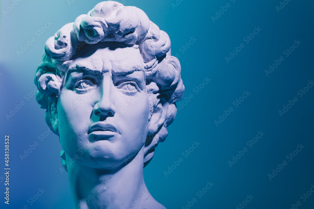 Gypsum copy of the sculpture David Michelangelo on blue background