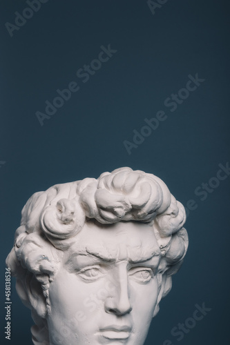 Gypsum copy of the sculpture David Michelangelo on gray background