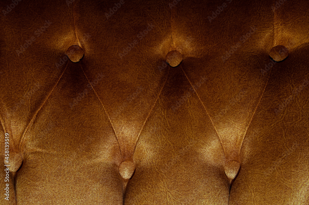 Fototapeta premium Dark natural luxury leather sofa textured background with faded light. Long exposure shot