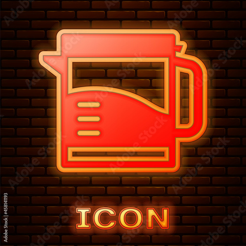 Glowing neon Electric kettle icon isolated on brick wall background. Teapot icon. Vector