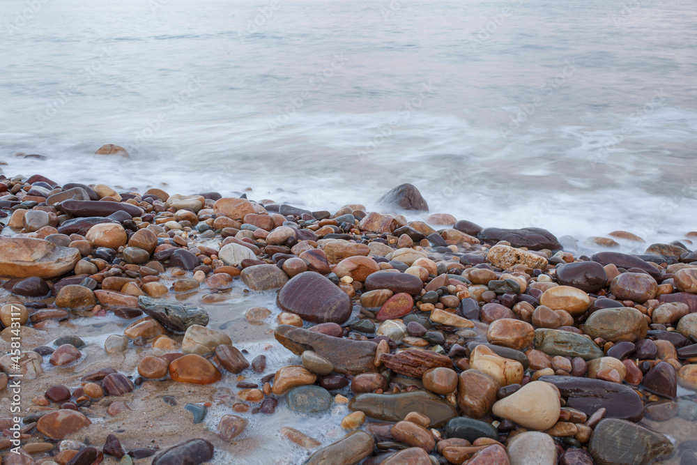 soft blue waves coming through colourful pebbles at the beach in Adelaide, South Australia soft blue waves coming through colourful pebbles at the beach in Adelaide, South Australia