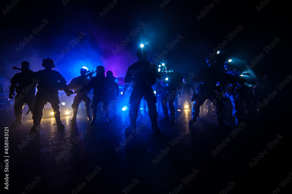 Anti-riot police give signal to be ready. Government power concept. Police in action. Smoke on a dark background with lights. Blue red flashing sirens. Dictatorship power
