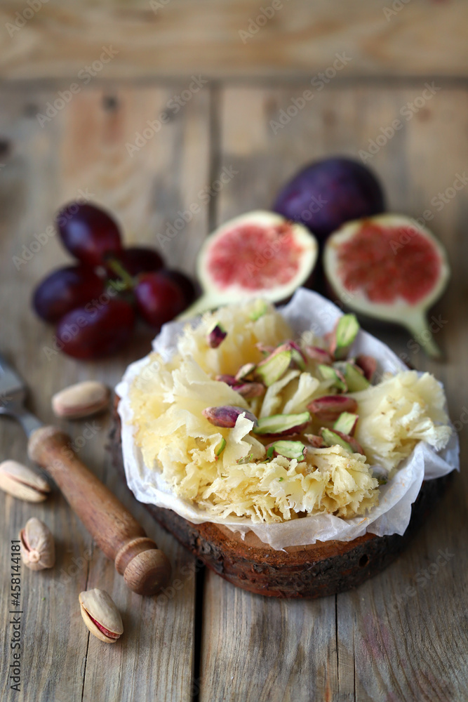 Cheese tet de moine with figs and pistachios.